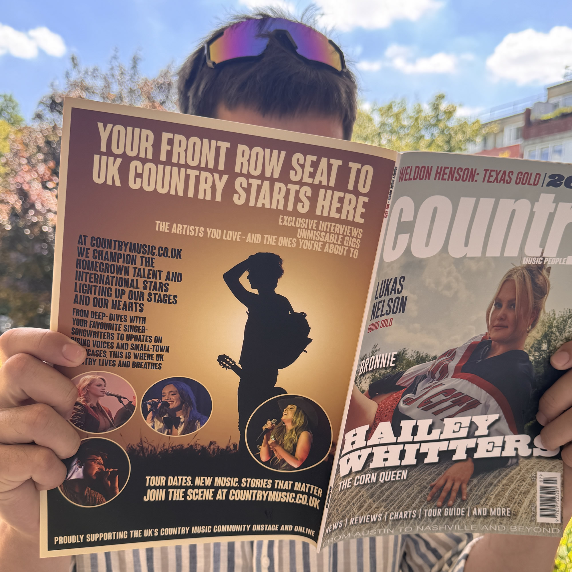 A fan reading about countrymusic.co.uk in Country Music People magazine