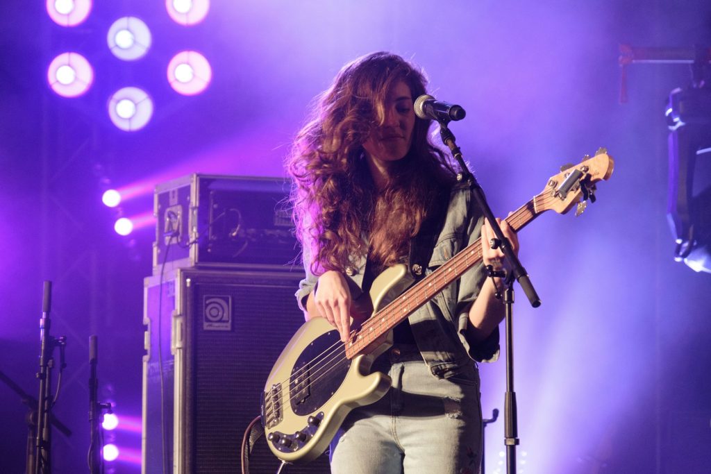 Photo of a woman playing a guitar on stage by Anton Mislawsky on Unsplash