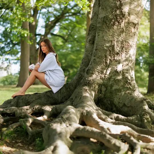 A woman sitting on a tree