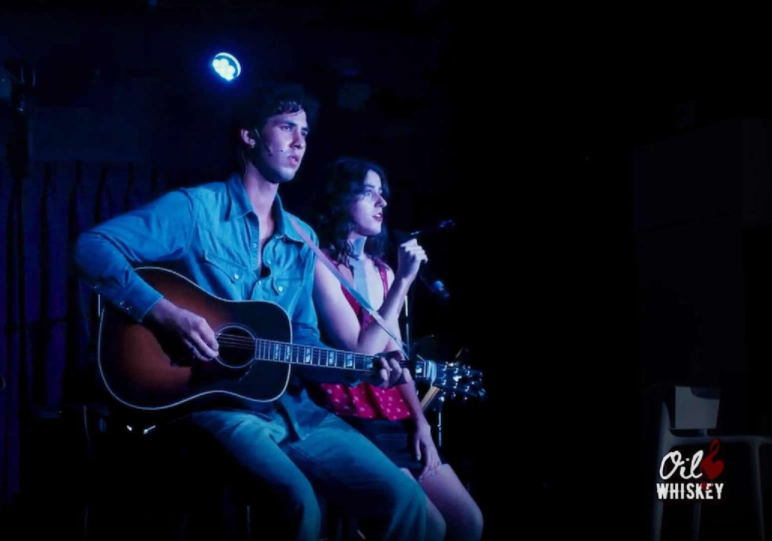 A man and woman playing guitar